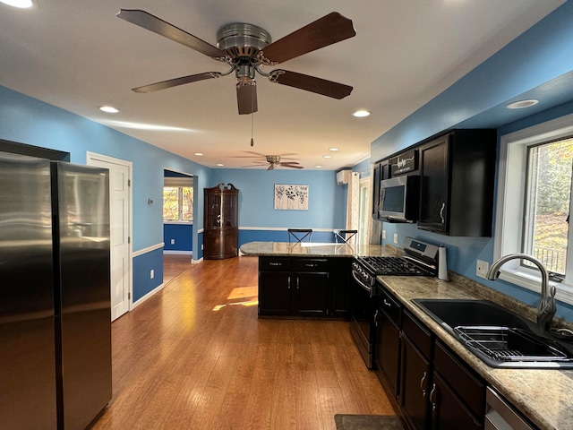 kitchen featuring a healthy amount of sunlight, sink, light hardwood / wood-style floors, and stainless steel appliances