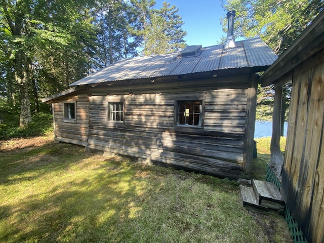 LOT14 Rowe Pond Rd, Pleasant Ridge Plt, ME 04920 - view of side of home with a lawn, metal roof, and an outbuilding