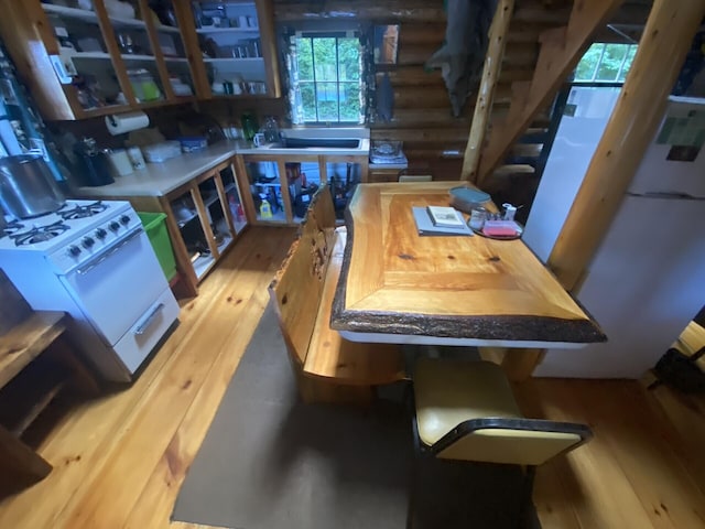 LOT14 Rowe Pond Rd, Pleasant Ridge Plt, ME 04920 - dining area featuring rustic walls, stairs, and wood finished floors