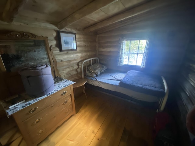 LOT14 Rowe Pond Rd, Pleasant Ridge Plt, ME 04920 - bedroom with light wood finished floors, beam ceiling, and wooden walls