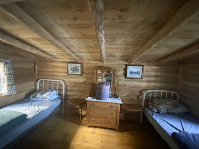 LOT14 Rowe Pond Rd, Pleasant Ridge Plt, ME 04920 - bedroom with wooden ceiling, beamed ceiling, log walls, and light wood-type flooring