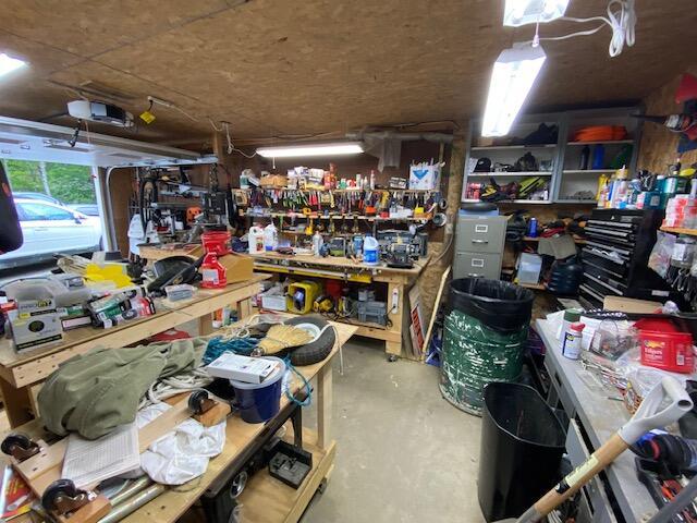 interior space featuring a garage door opener and a workshop area