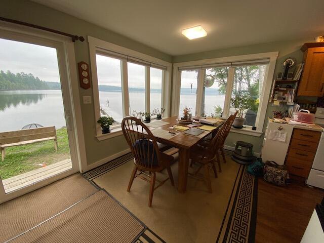 sunroom featuring a water view and a wealth of natural light