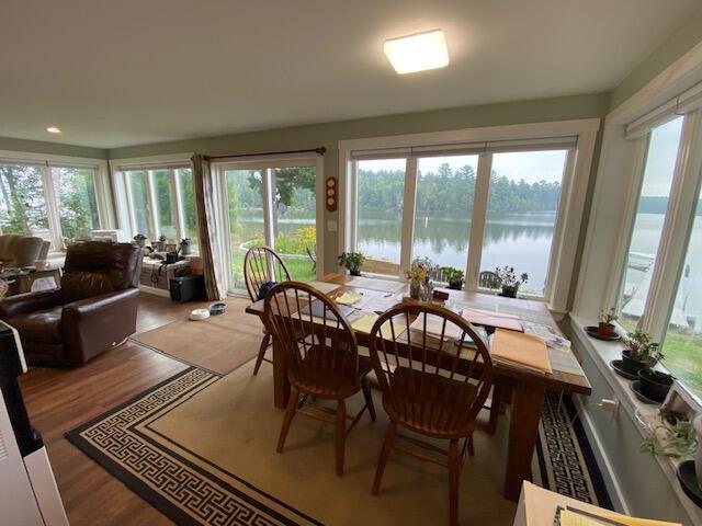 sunroom with a water view and a wealth of natural light