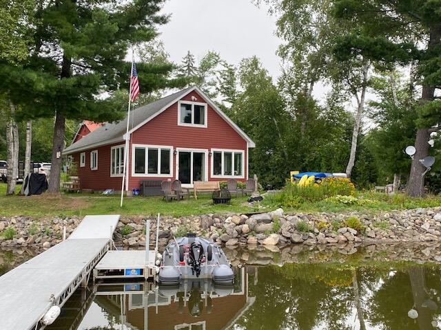 rear view of house featuring a water view