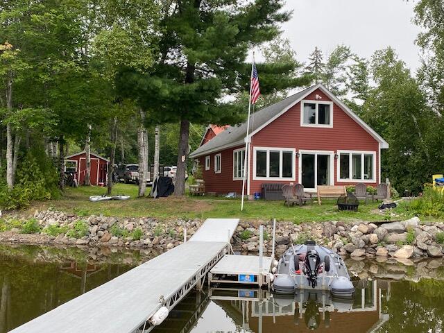 dock area with a water view and a lawn