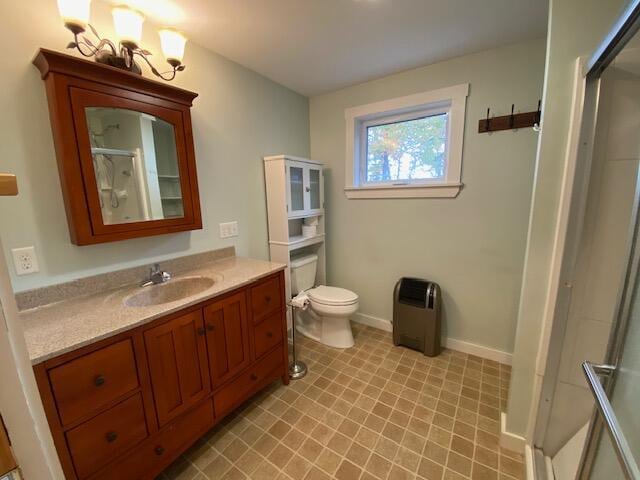 bathroom with vanity, toilet, and a shower with shower door