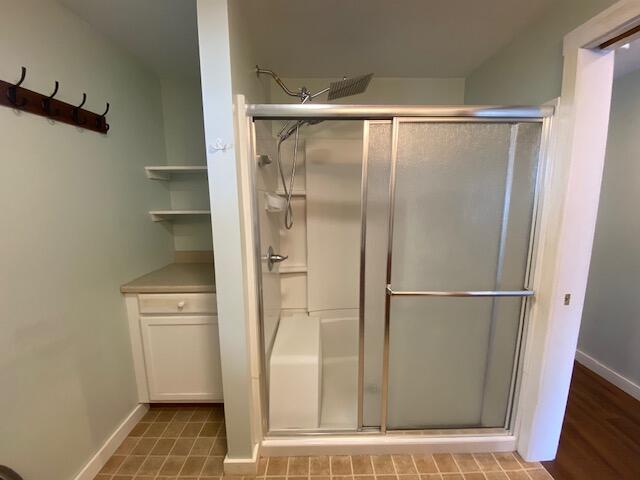 bathroom with a shower with door