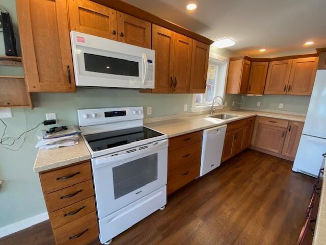 kitchen featuring dark hardwood / wood-style flooring, sink, and white appliances