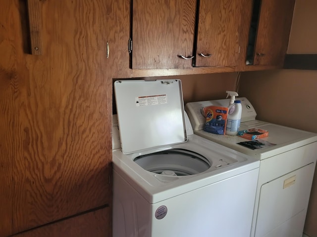 washroom with cabinets and separate washer and dryer