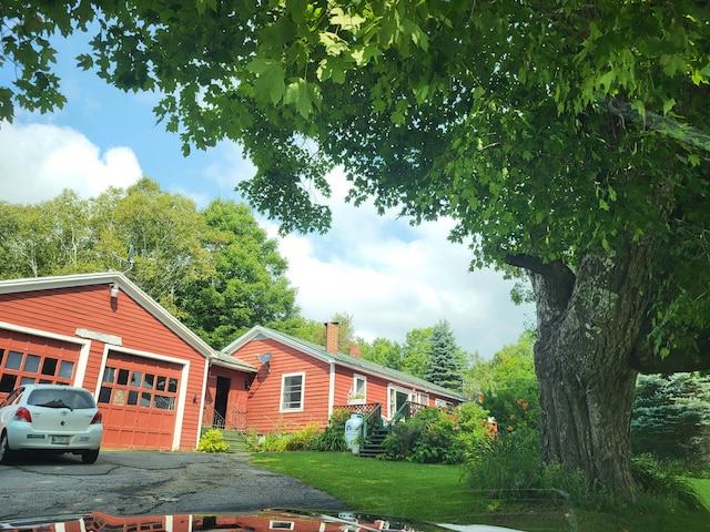 exterior space featuring a lawn and a garage