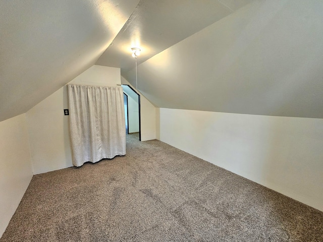 bonus room featuring carpet floors and vaulted ceiling