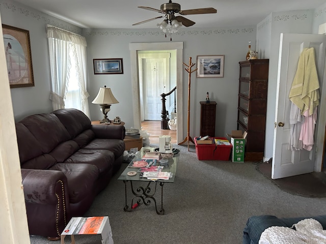 living room with ceiling fan and carpet