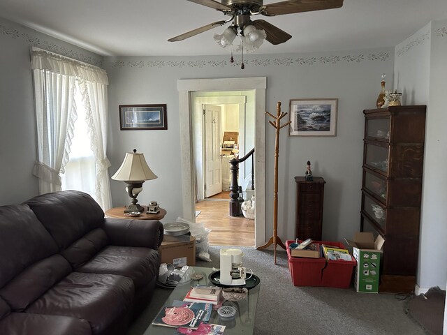 living room featuring ceiling fan and carpet