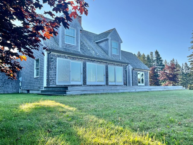 rear view of house with a yard