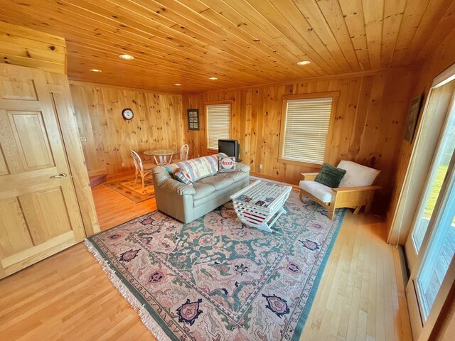 living room with wooden ceiling, light hardwood / wood-style flooring, and wooden walls