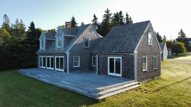 rear view of property featuring a yard and a wooden deck