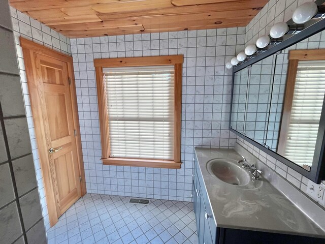 bathroom with tile walls and a healthy amount of sunlight