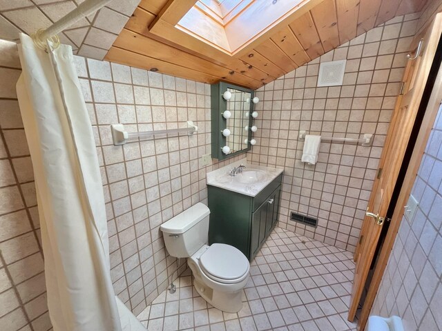 bathroom featuring vaulted ceiling with skylight, tile walls, vanity, and wood ceiling