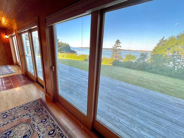 doorway to outside featuring a water view and wood-type flooring