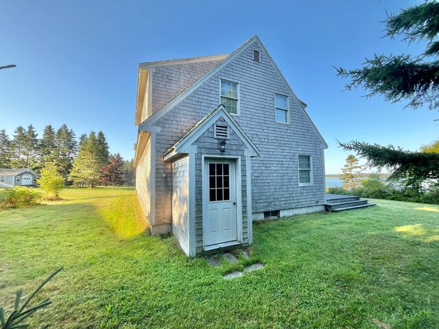 rear view of property with a lawn