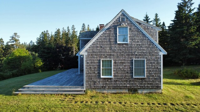 view of property exterior with a lawn