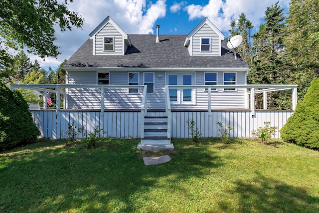 rear view of house featuring a yard