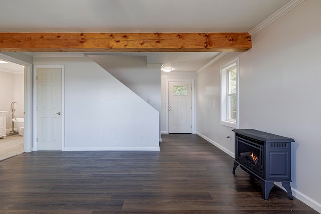 foyer featuring crown molding, dark wood-type flooring, a wood stove, and beam ceiling