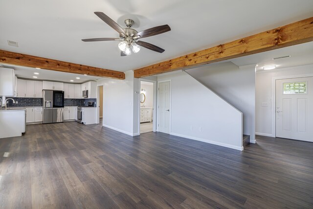 unfurnished living room featuring ceiling fan, sink, dark hardwood / wood-style flooring, and beam ceiling