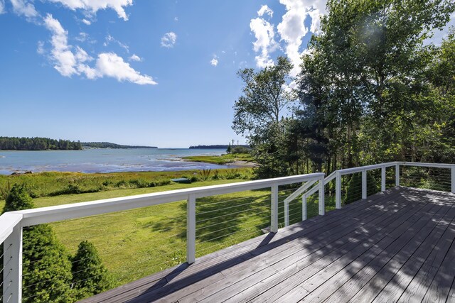 deck with a water view and a yard