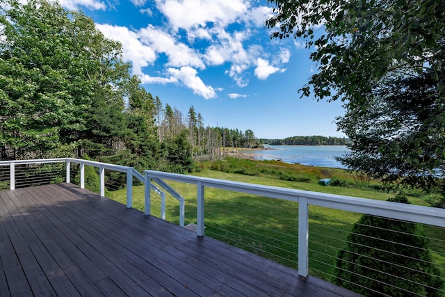 wooden terrace featuring a water view and a lawn