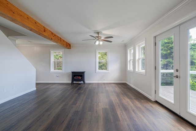 unfurnished living room with a wealth of natural light, dark hardwood / wood-style flooring, and a wood stove