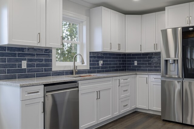 kitchen featuring tasteful backsplash, dark hardwood / wood-style flooring, stainless steel appliances, and white cabinetry