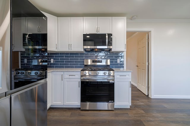 kitchen with backsplash, stainless steel appliances, and dark hardwood / wood-style flooring