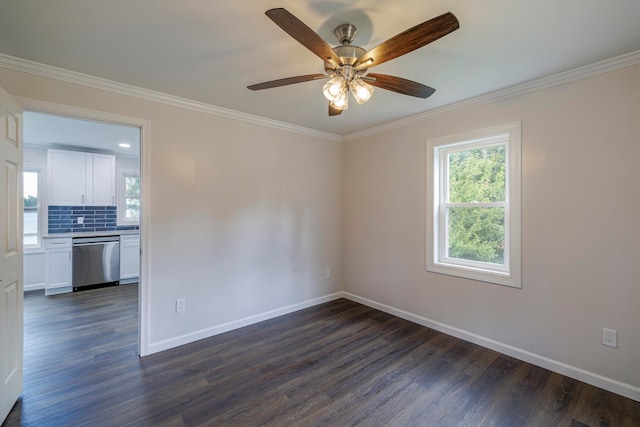 empty room featuring ceiling fan, dark wood-type flooring, and crown molding