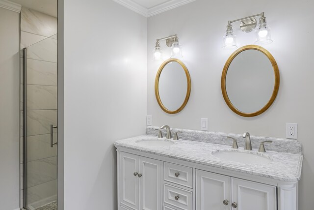 bathroom featuring dual vanity, a shower with door, and crown molding