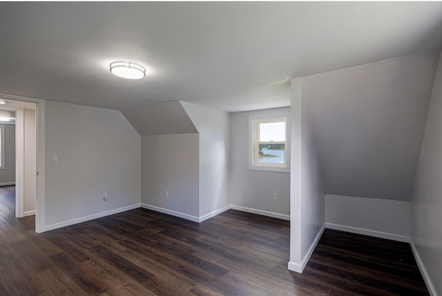 bonus room featuring dark wood-type flooring and lofted ceiling