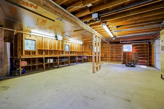 garage with a garage door opener and a workshop area