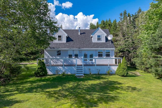 rear view of house with a yard and a deck