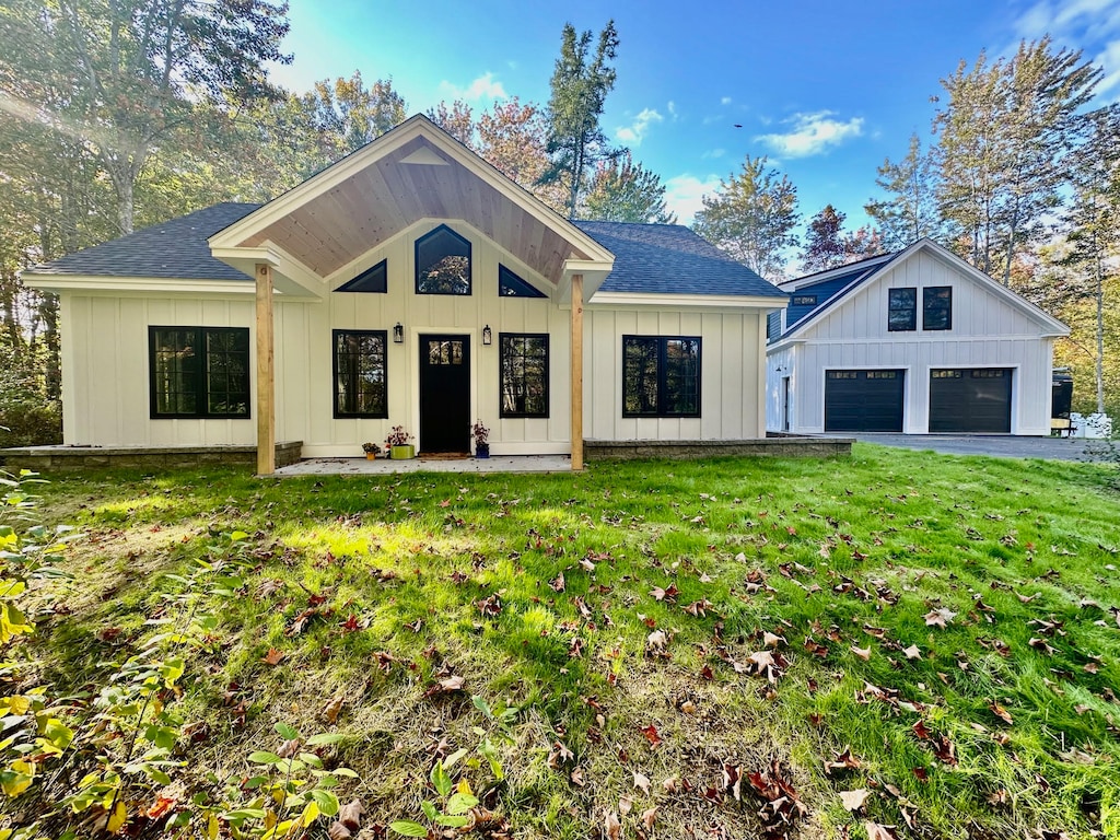 59 Lincolnville Ave, Belfast, ME 04915 - modern farmhouse featuring roof with shingles, board and batten siding, and a front yard