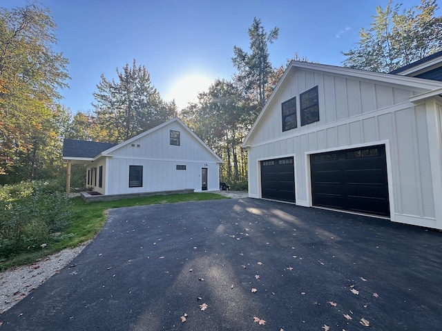 view of home's exterior featuring a garage, driveway, and board and batten siding