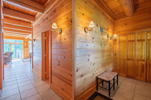 hall featuring wood ceiling, wood walls, and beam ceiling