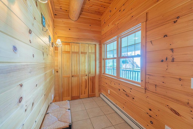 corridor with light tile patterned floors, wood ceiling, wood walls, a baseboard heating unit, and beam ceiling