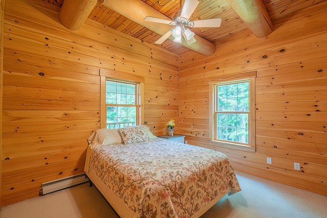 carpeted bedroom featuring multiple windows, beamed ceiling, and baseboard heating