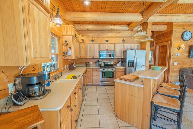kitchen with stainless steel appliances, light countertops, and light brown cabinets