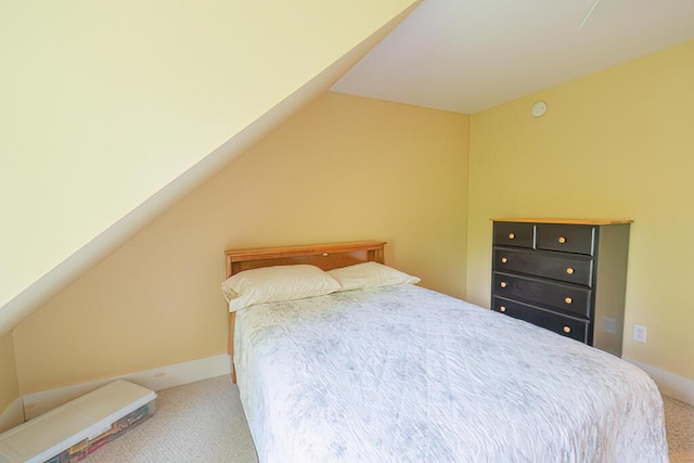 bedroom featuring carpet flooring and vaulted ceiling