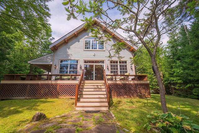 rear view of house featuring a yard and a wooden deck