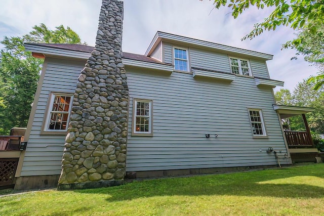 rear view of property with a yard and a chimney