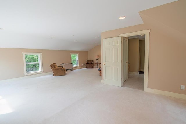 interior space with vaulted ceiling, recessed lighting, baseboards, and light colored carpet