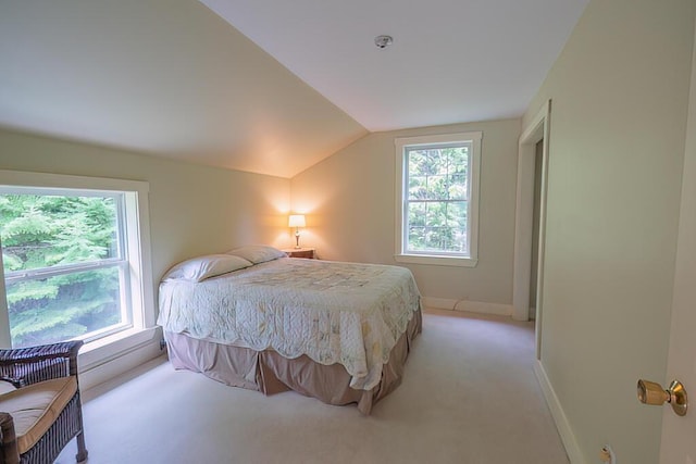 bedroom with light carpet, baseboards, and lofted ceiling